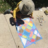 child making sidewalk art