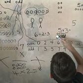 boy at whiteboard doing math