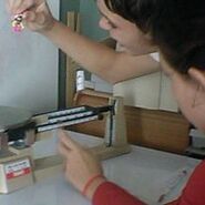 Picture of 2 teens using a triple-beam balance